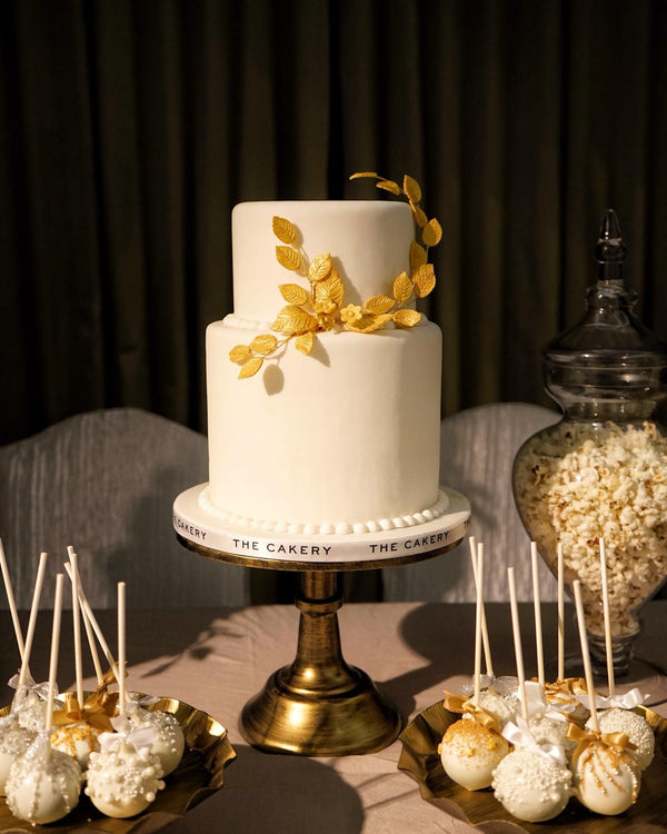 White wedding cake with gold leaves