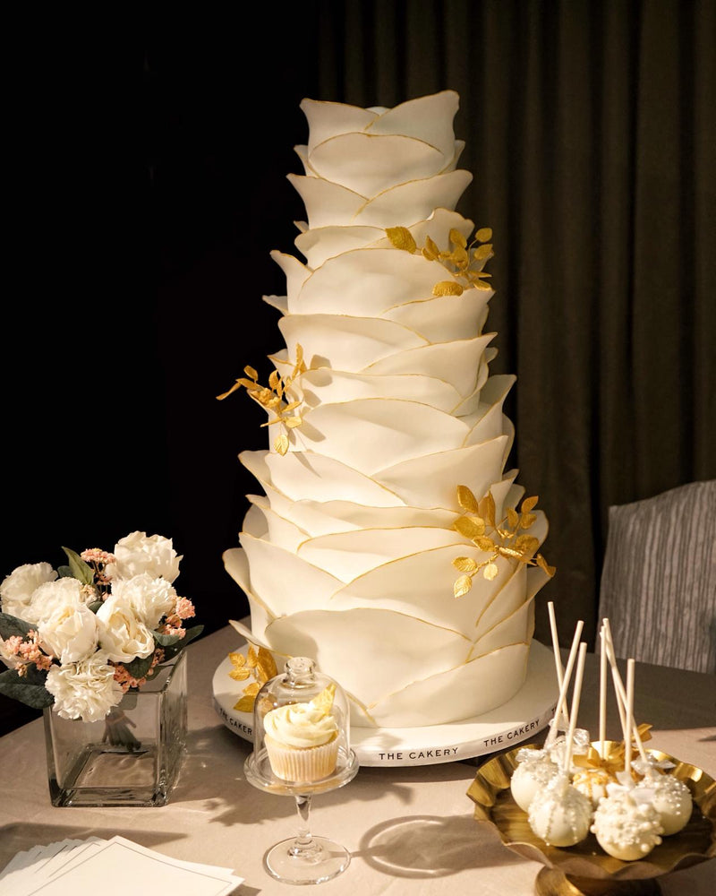 Ruffle wedding cake with gold leaves